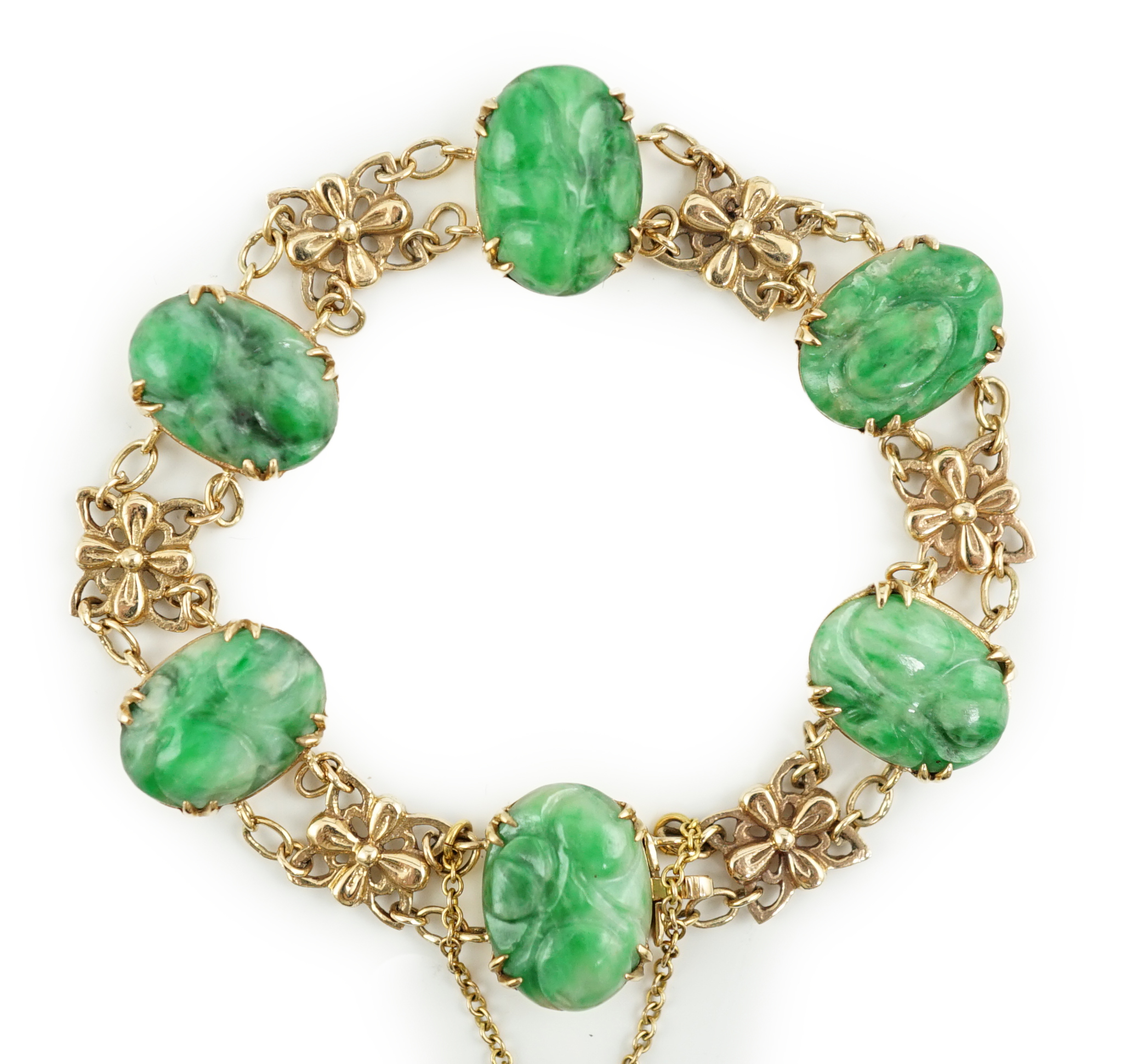 An early 20th century 9ct gold butterfly link and six stone carved jade set bracelet